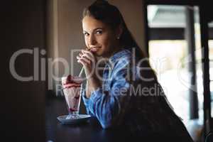Portrait of beautiful woman having milkshake
