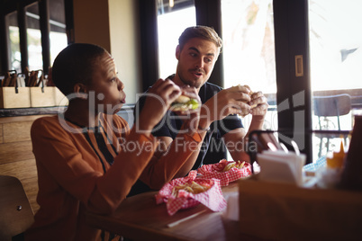 Happy couple eating burger