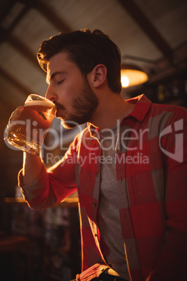 Young man having mug of beer