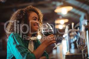 Woman having wine at bar counter