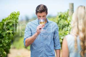 Young man drinking white wine