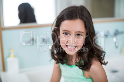Girl smiling at camera in bathroom