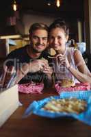 Portrait of happy couple having fast food