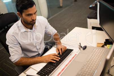 Businessman typing on keyboard at office dsek