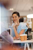 Businesswoman looking away at desk in office