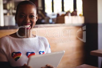 Portrait of happy woman using digital tablet