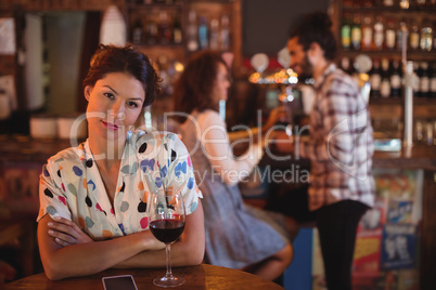 Portrait of smiling woman with arms crossed