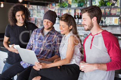 Group friends using laptop in restaurant