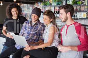 Group friends using laptop in restaurant
