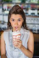 Portrait of young woman drinking smoothie