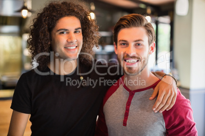 Portrait of smiling male friends in restaurant