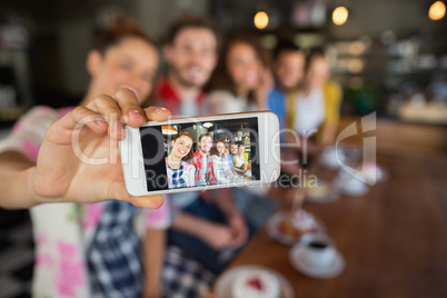 Friends taking photo in pub