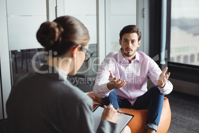 Counselor consoling unhappy man