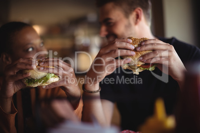 Happy couple having burger