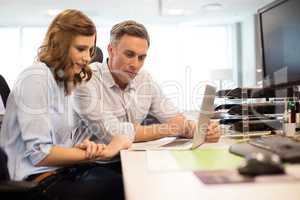 Business colleagues working on laptop at desk