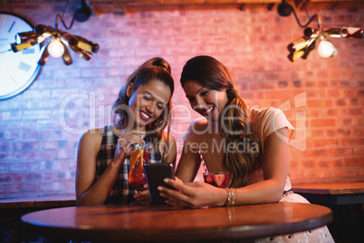 Two young women using mobile phone