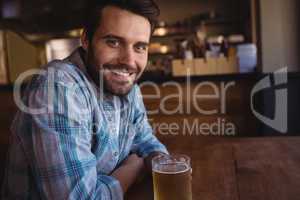 Portrait of happy man having beer