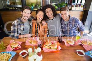 Cheerful friends having lunch in restaurant