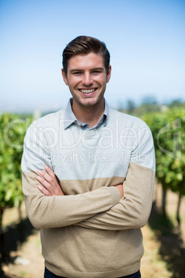 Portrait of man with arms crossed at vineyard