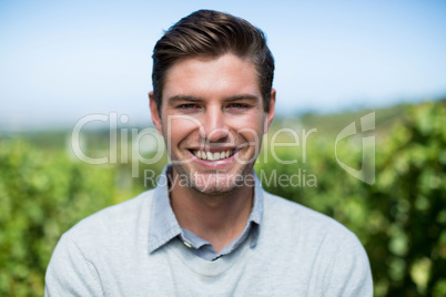 Portrait of smiling young man at vineyard