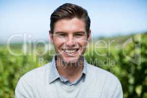 Portrait of smiling young man at vineyard