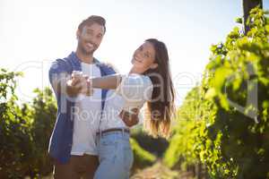 Portrait of young couple dancing at vineyard