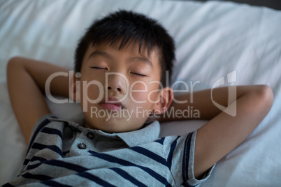 Boy sleeping on bed in bedroom Boy sleeping on bed in bedroom