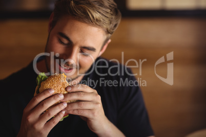Happy man eating burger