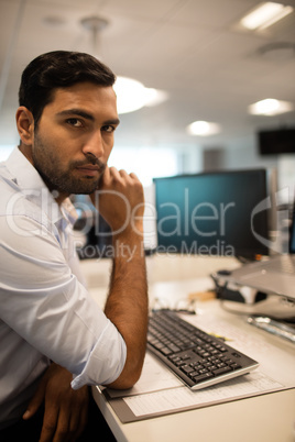 Serious business executive sitting in office