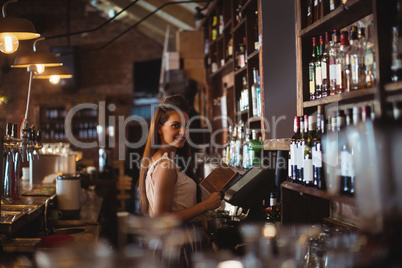 Female bar tender holding menu