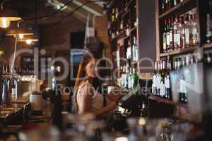 Female bar tender holding menu