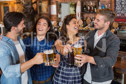 Cheerful friends enjoying in pub