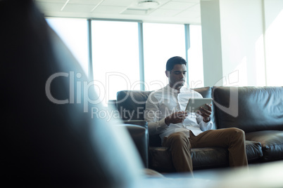Businessman using digital computer in office
