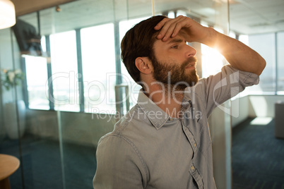 Sad businessman leaning on glass