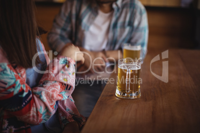 Couple having beer at counter