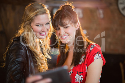 Smiling friends taking selfie