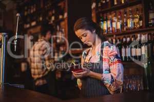 Waitress taking an order on notepad at counter