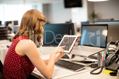 Side view of businesswoman using digital tablet in office