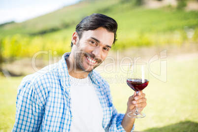 Portrait of smiling man holding red wine
