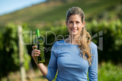 Portrait of woman holding wine bottle