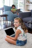 Smiling girl using laptop in living room