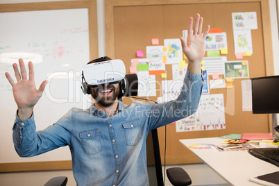 Businessman experiencing virtual reality in office