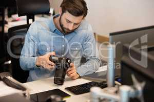 Professional photographer using camera in creative office