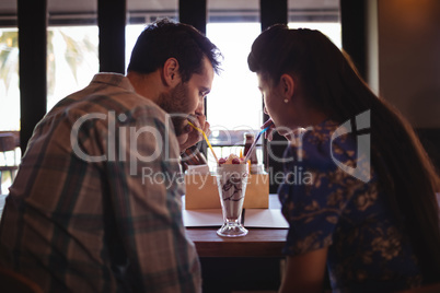 Couple having milkshake