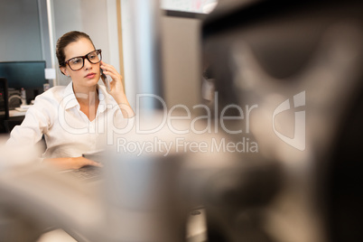 Businesswoman using mobile phone at office