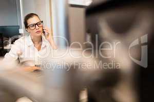 Businesswoman using mobile phone at office