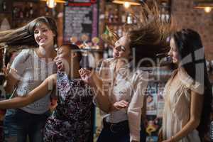 Carefree female friends dancing