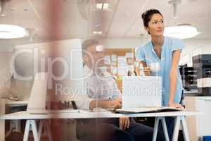 Business colleagues looking away seen through glass