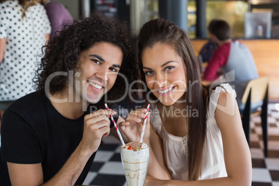 Portrait of smiling couple having drink in restaurant