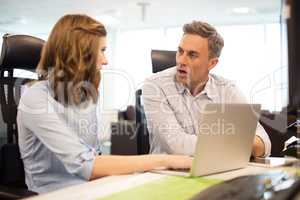 Business colleagues discussing while working in office